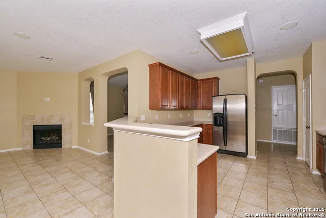 a kitchen with refrigerator and cabinets