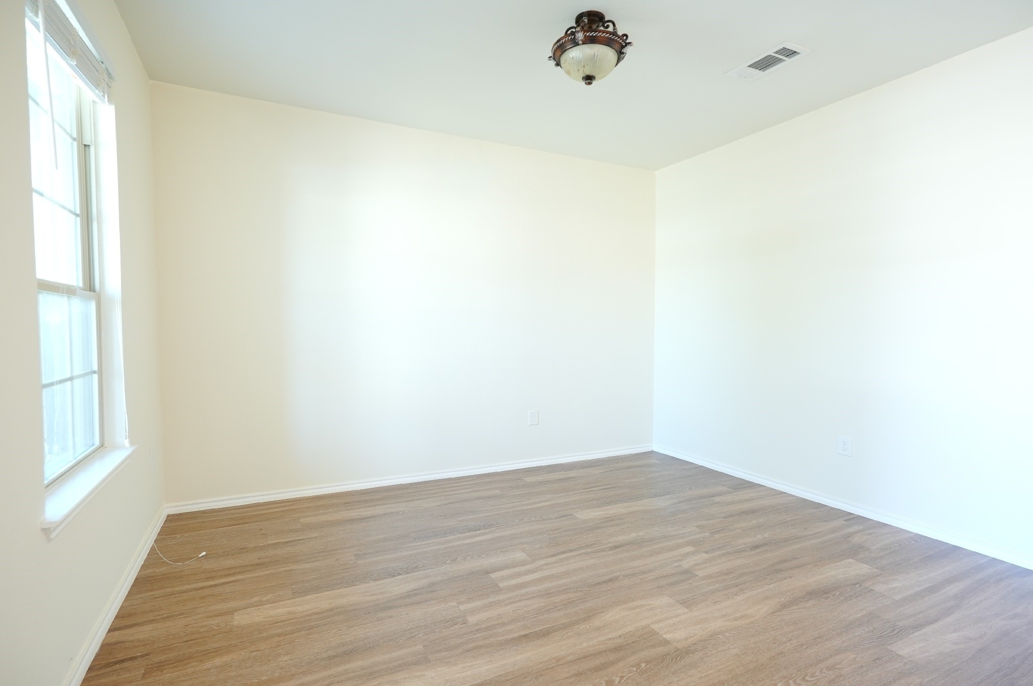 4611 Windmill Run Drive Houston, TX 77069 - Photo 11 of 36 a view of a room with wooden floor and windows in a room