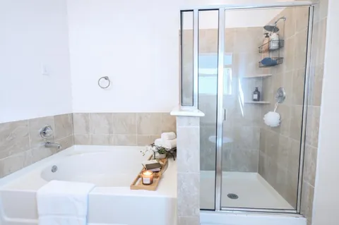 a bathroom with a tub and shower