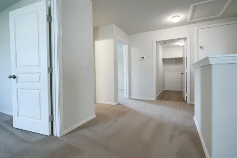a view of an empty room and closet area