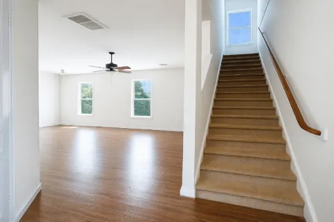 a view of entryway and hall with wooden floor
