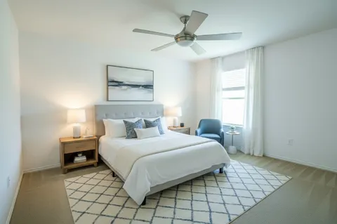 a bedroom with a bed and a window