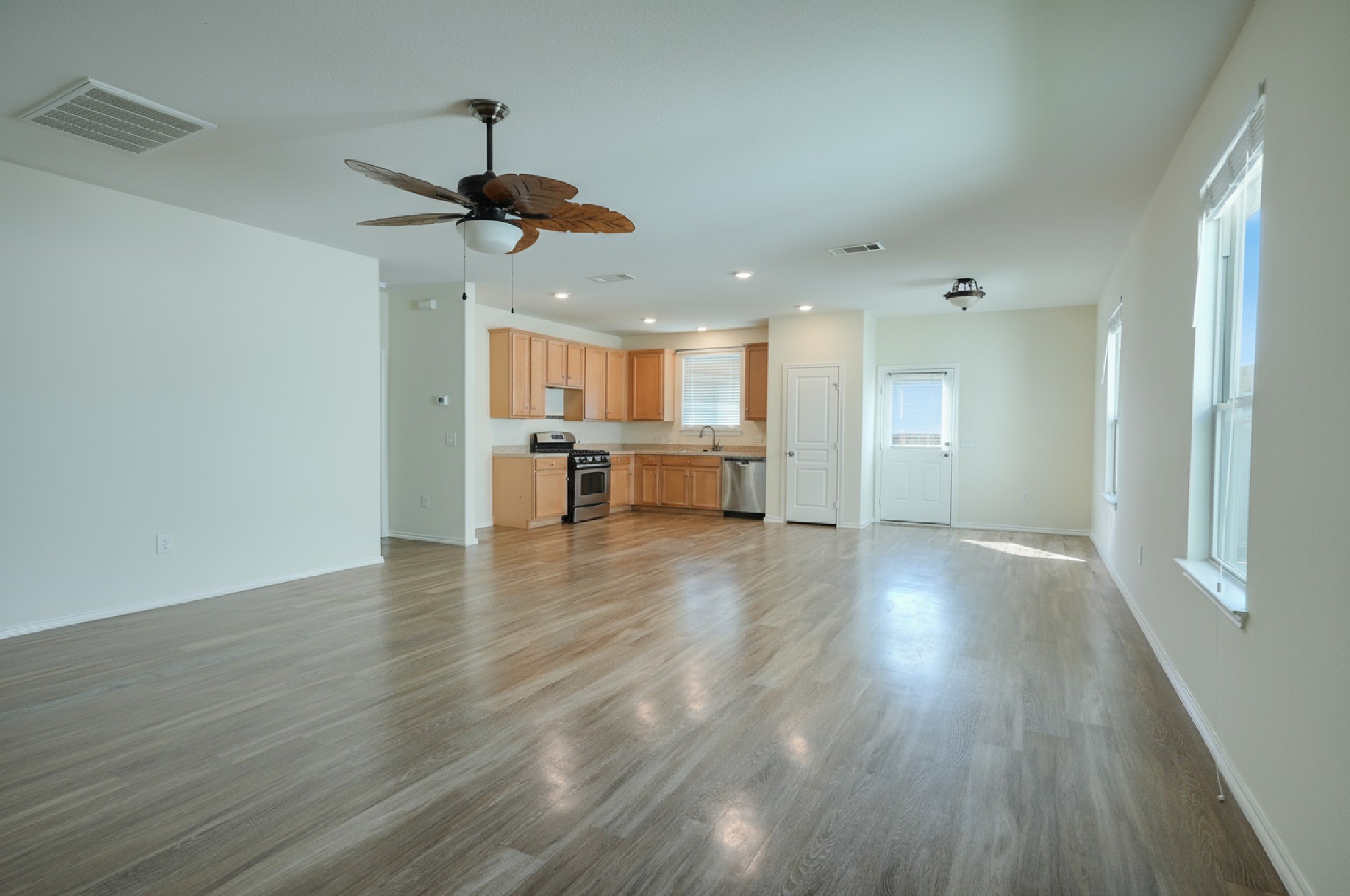 4611 Windmill Run Drive Houston, TX 77069 - Photo 3 of 36 a view of a room with wooden floor a ceiling fan and windows