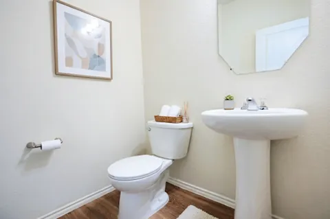 a bathroom with a sink mirror and toilet