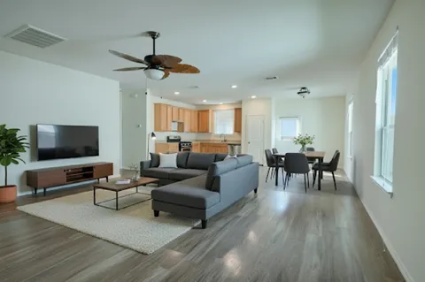 a living room with furniture and a flat screen tv