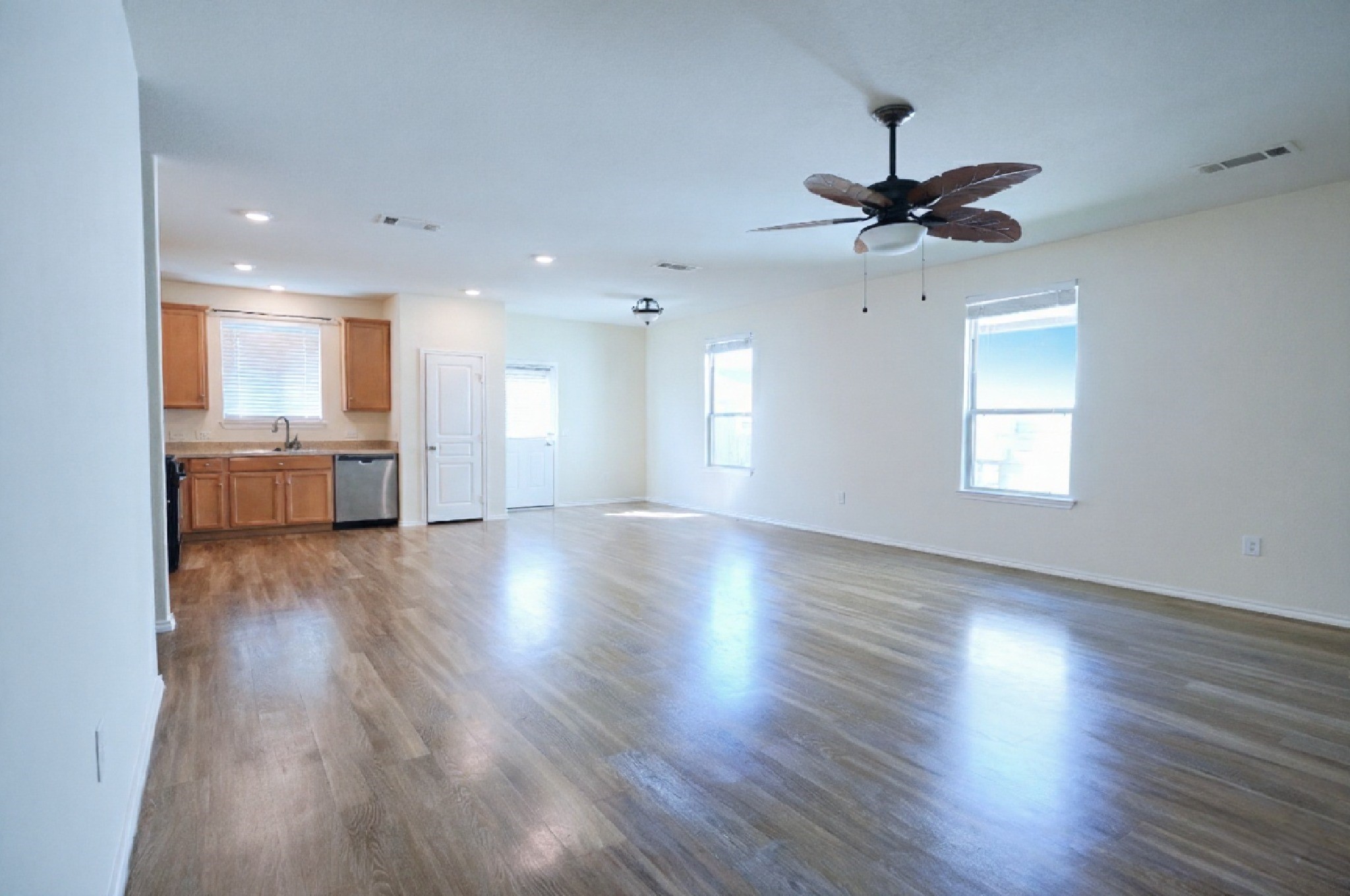 4611 Windmill Run Drive Houston, TX 77069 - Photo 5 of 36 a view of a kitchen and an empty room with wooden floor and a window