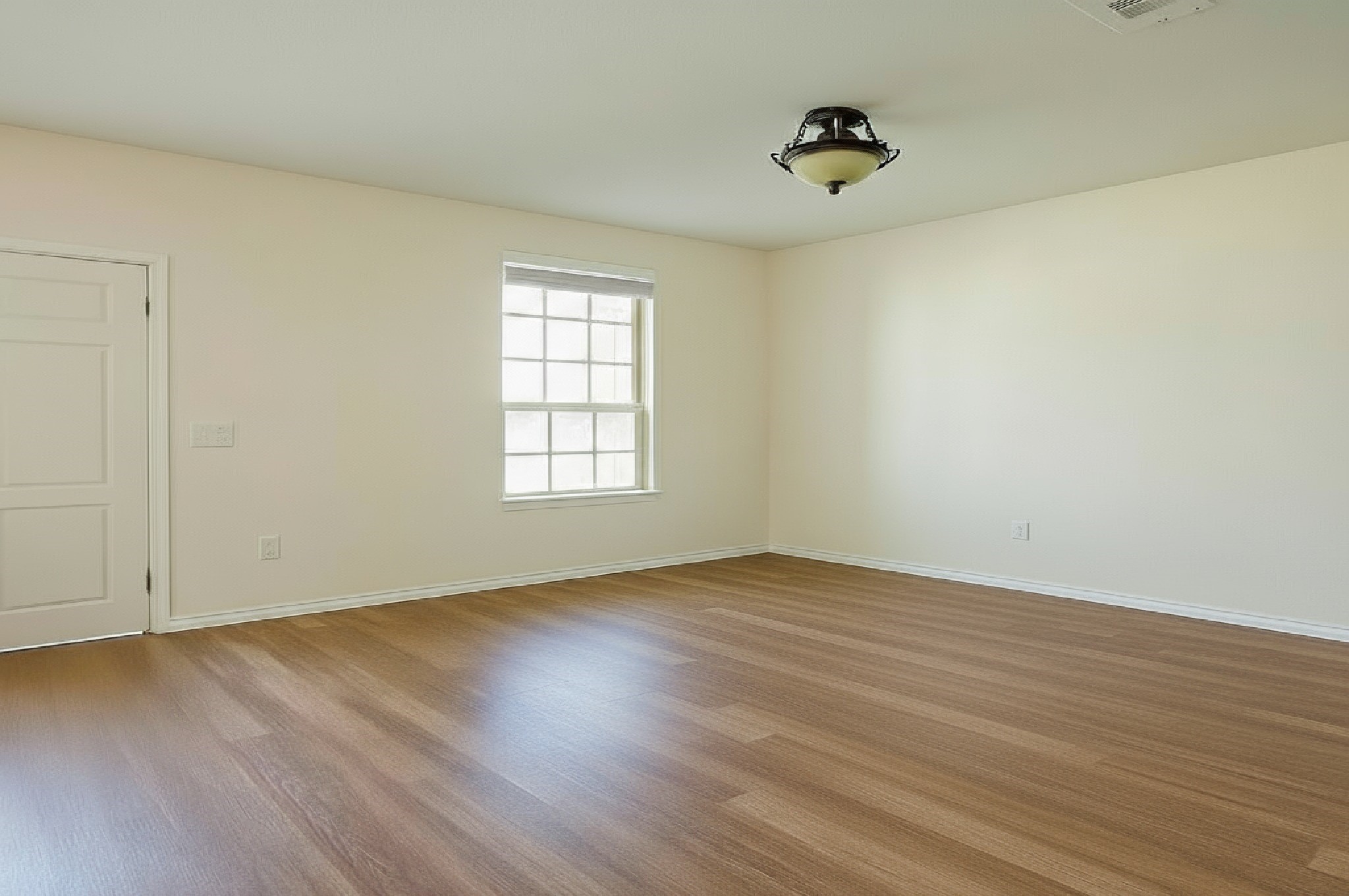 4611 Windmill Run Drive Houston, TX 77069 - Photo 6 of 36 an empty room with wooden floor and windows