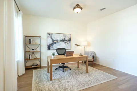a work room with furniture and wooden floor