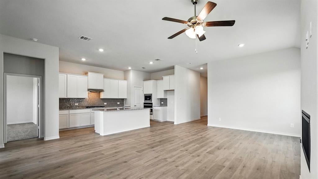 4191 Waldron Trail Forney, TX 75126 - Photo 9 of 20 Open-concept living space featuring wood-finish flooring, recessed lighting, and a modern ceiling fan
