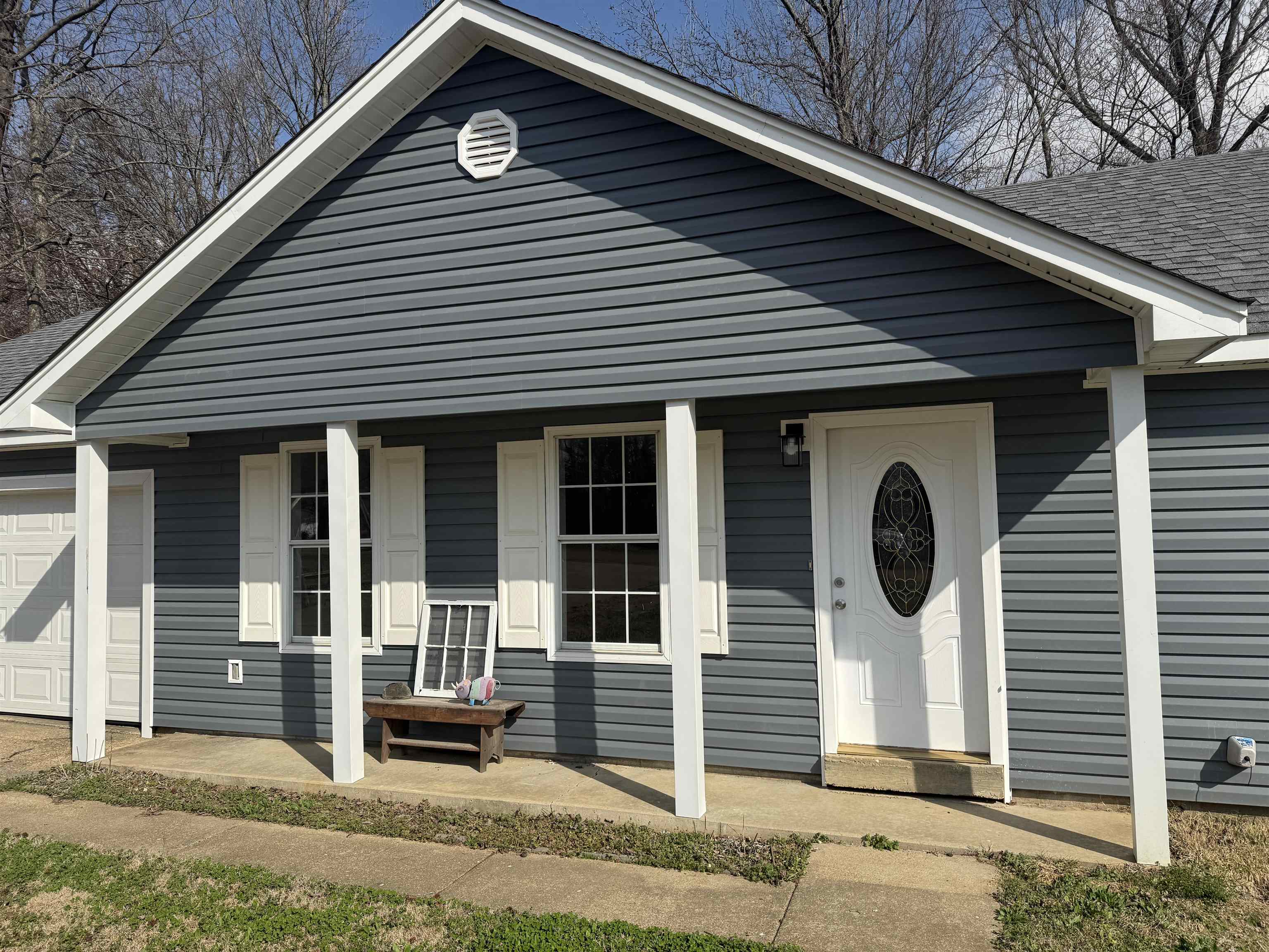 260 Chisolm Trail Road Atoka, TN 38004 - Photo 3 of 21 View of front of property featuring a porch and a garage