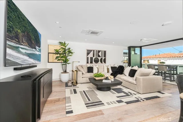 a living room with furniture large window and a flat screen tv