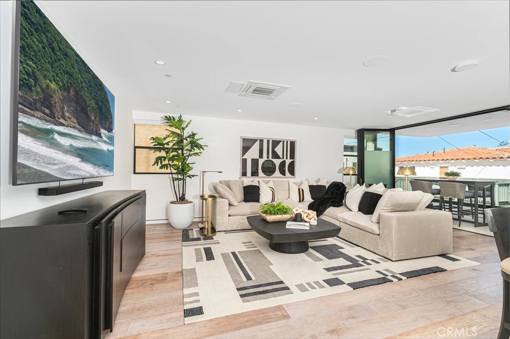 1034 West Balboa Boulevard, Unit B Newport Beach, CA 92661 - Photo 2 of 33 a living room with furniture large window and a flat screen tv