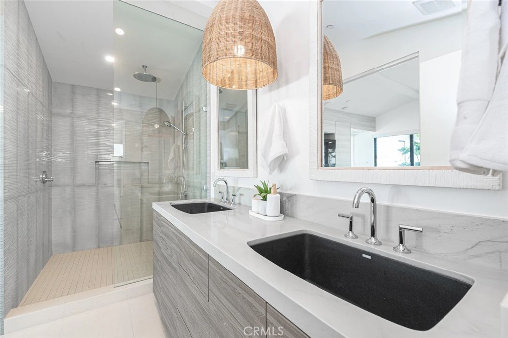 1034 West Balboa Boulevard, Unit B Newport Beach, CA 92661 - Photo 22 of 33 a bathroom with a sink a vanity a mirror and shower
