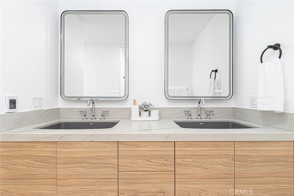1034 West Balboa Boulevard, Unit B Newport Beach, CA 92661 - Photo 26 of 33 a bathroom with double vanity sinks and a mirror