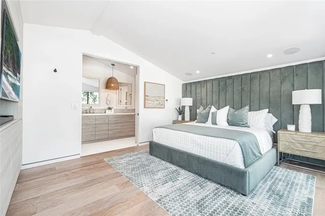 a large white bed in a room next to a window