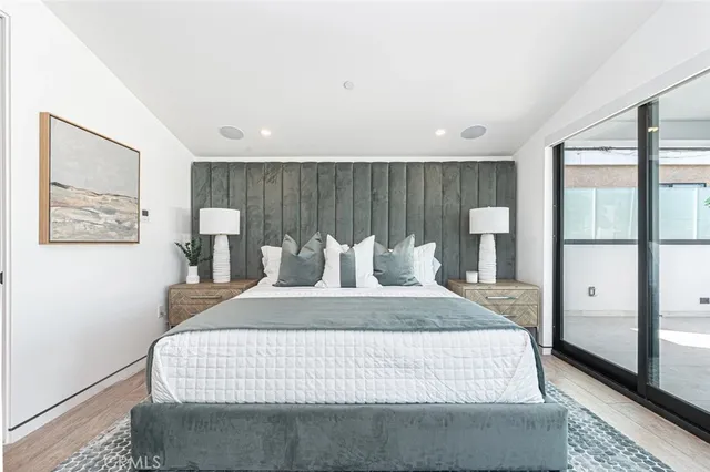 a large bedroom with a large bed and large windows