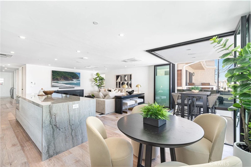 1034 West Balboa Boulevard, Unit B Newport Beach, CA 92661 - Photo 8 of 33 a living room with furniture and a dining table with potted plants