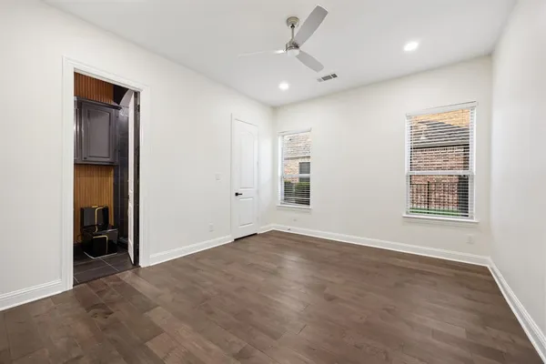 an empty room with windows and closet