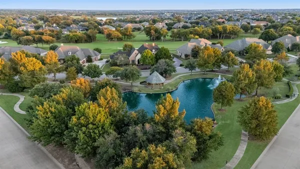 an aerial view of lake residential houses with outdoor space and swimming pool