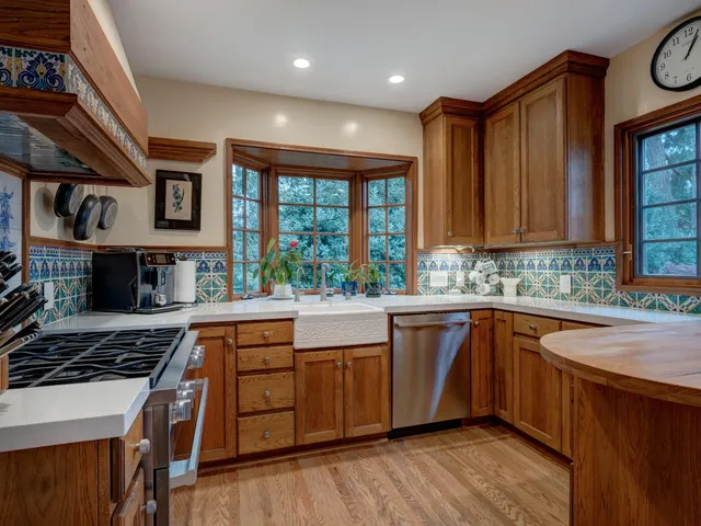 a kitchen with stainless steel appliances granite countertop a stove and a sink