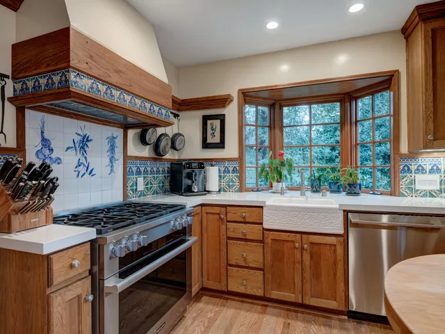 a kitchen with stainless steel appliances granite countertop a stove and a sink