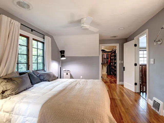 a bedroom with a bed and a large window