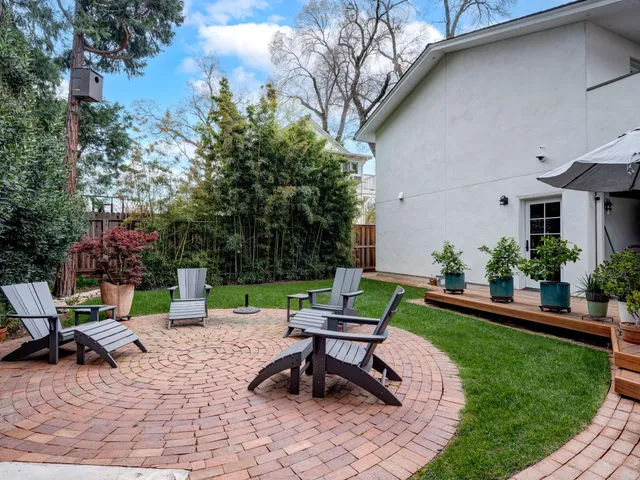 a view of a backyard with sitting area