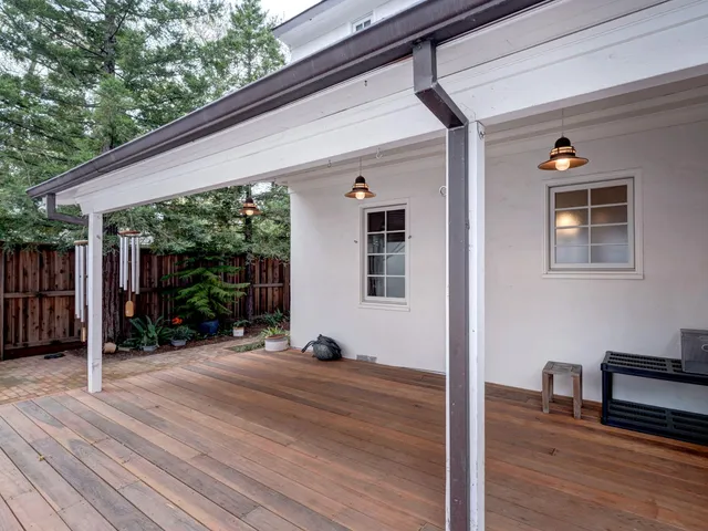 a view of a porch with wooden floor and fence