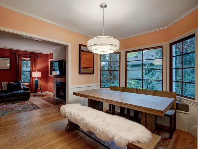 a dining room with furniture a chandelier and wooden floor