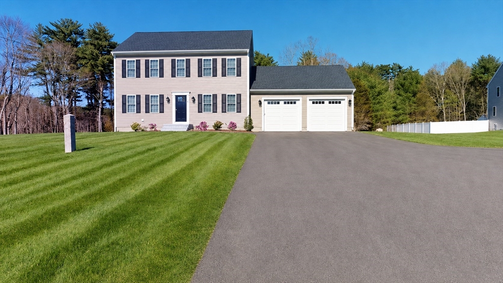 287 Wareham Street Middleboro, MA 02346 - Photo 22 of 28 a front view of a house with a yard and garage