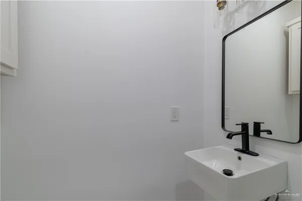 a bathroom with a sink and mirror