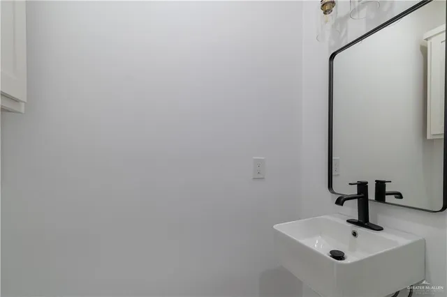 a bathroom with a sink and mirror
