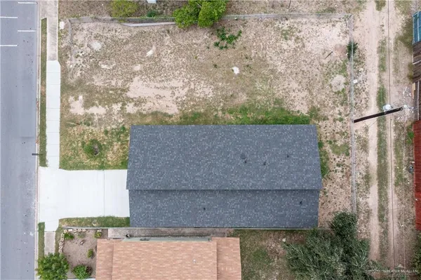a aerial view of a house with a yard and garage
