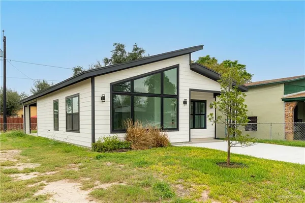 a house that has a tree in front of it
