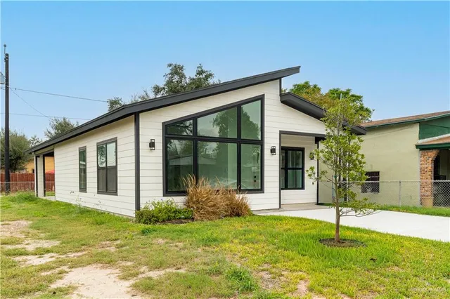 a house that has a tree in front of it
