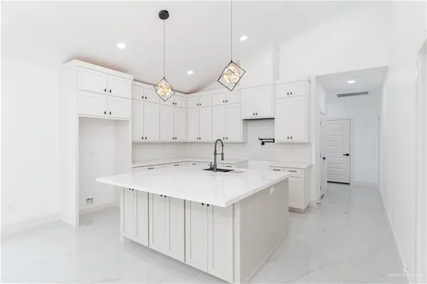 a large kitchen with a lot of counter space and a sink