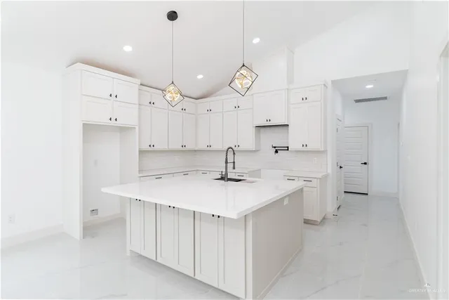 a large kitchen with a lot of counter space and a sink