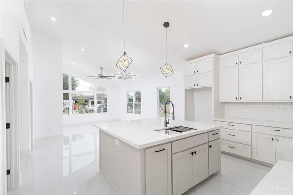 a kitchen with cabinets and window