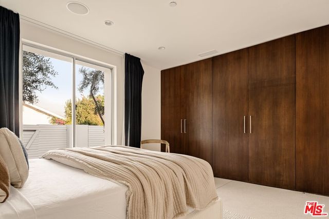 a bathroom with a double vanity sink a toilet and a mirror