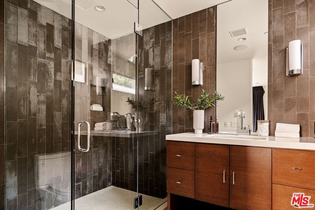 a bedroom with a bed and large windows