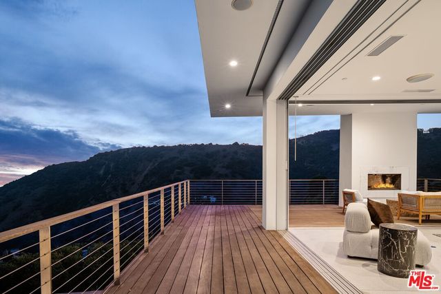 a view of a balcony with two chairs and a table