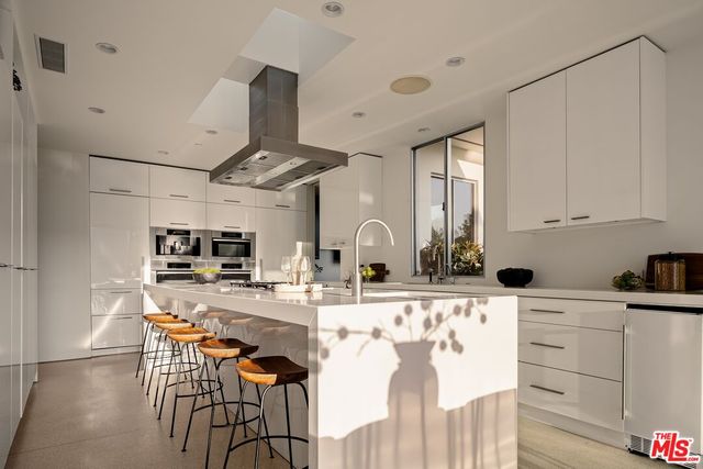 a kitchen with stainless steel appliances kitchen island granite countertop a sink and cabinets
