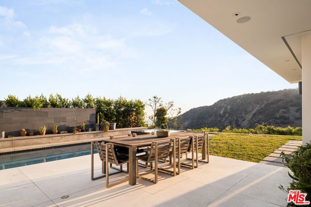 a view of a terrace with furniture and city view