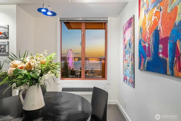 a view of a dining room with furniture and a potted plant