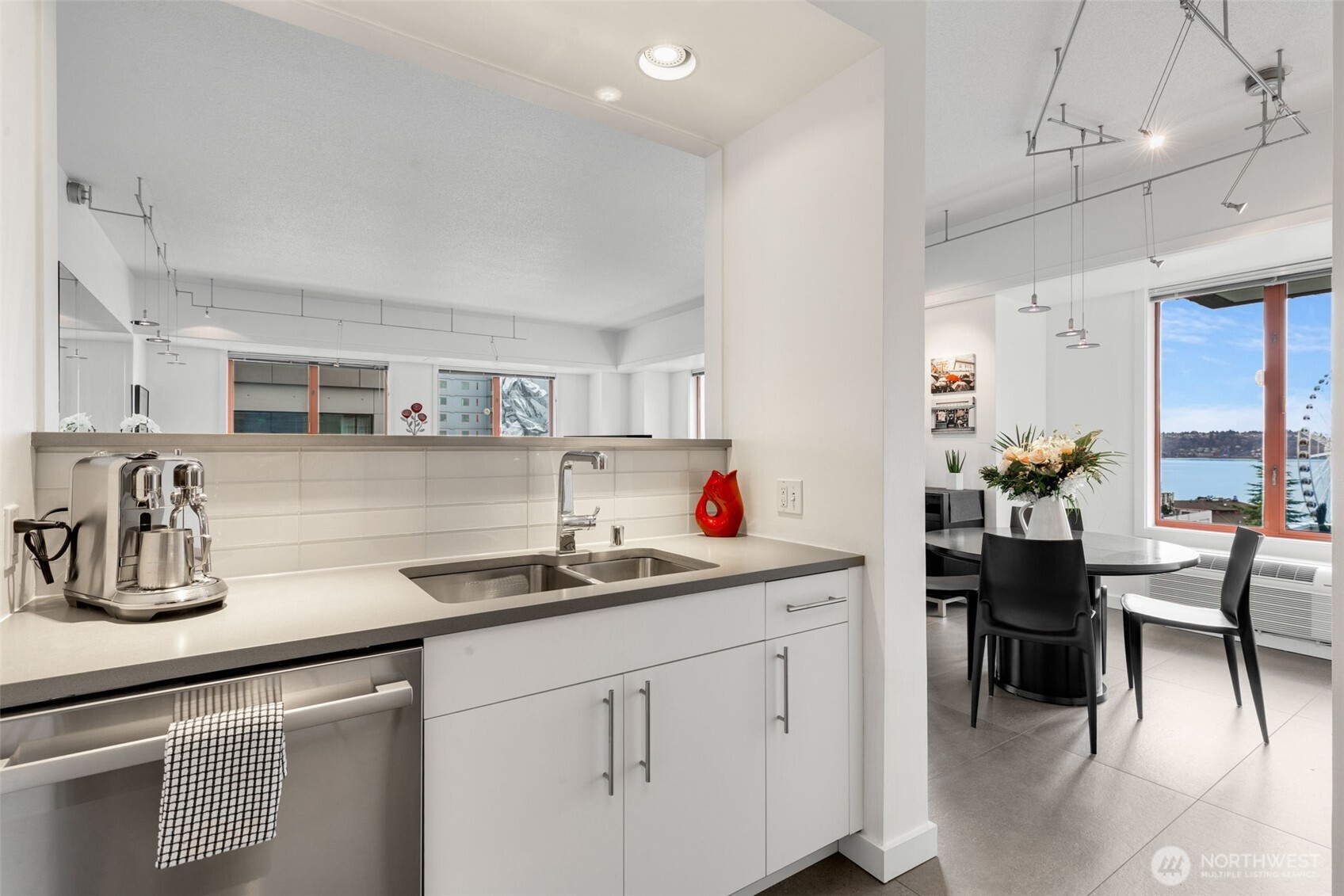 98 Union Street, Unit 206 Seattle, WA 98101 - Photo 12 of 35 a kitchen with a sink cabinets and counter space