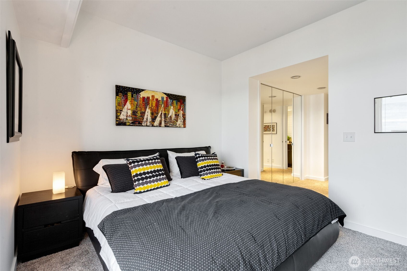 98 Union Street, Unit 206 Seattle, WA 98101 - Photo 17 of 35 a bedroom with a bed and a painting on the wall