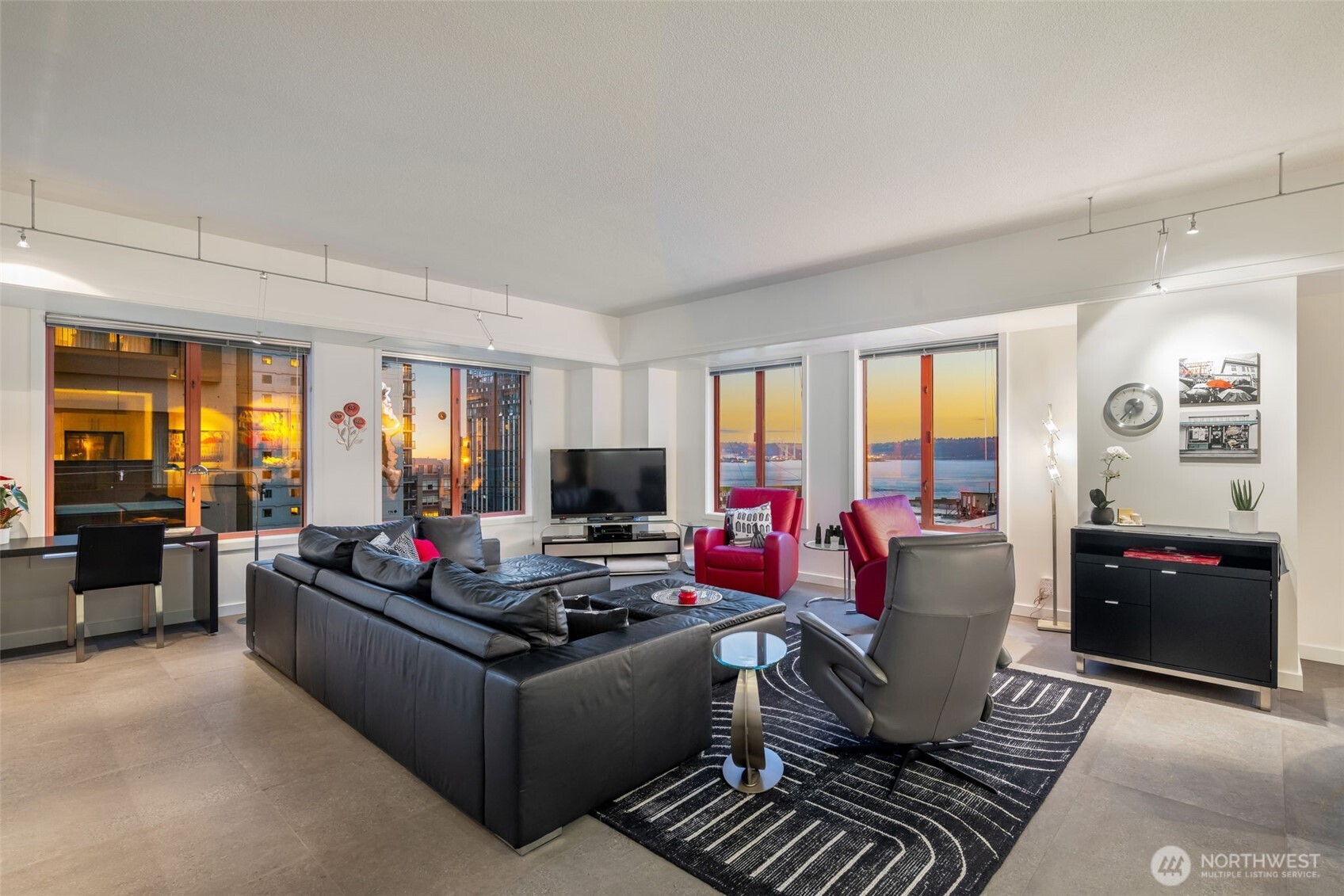98 Union Street, Unit 206 Seattle, WA 98101 - Photo 21 of 35 a living room with furniture and a flat screen tv