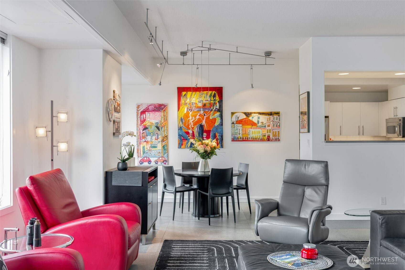 98 Union Street, Unit 206 Seattle, WA 98101 - Photo 25 of 35 a living room with furniture a rug and wall paintings