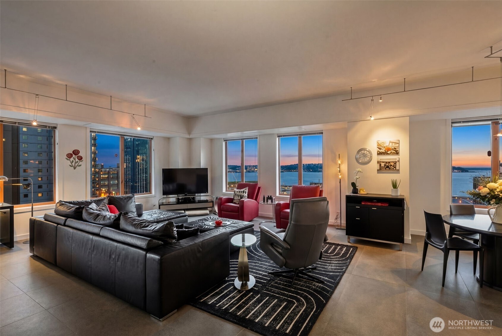 98 Union Street, Unit 206 Seattle, WA 98101 - Photo 27 of 35 a living room with furniture and a flat screen tv