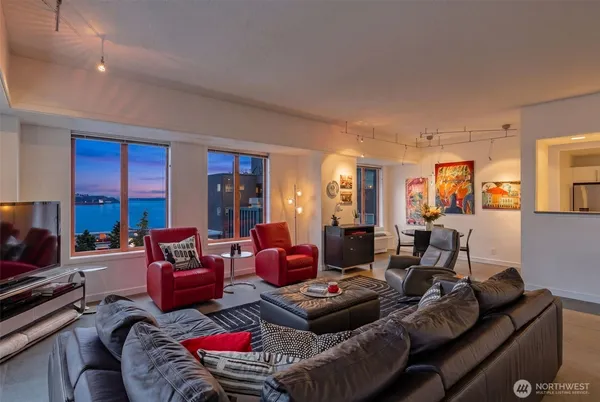 a living room with furniture and a floor to ceiling window